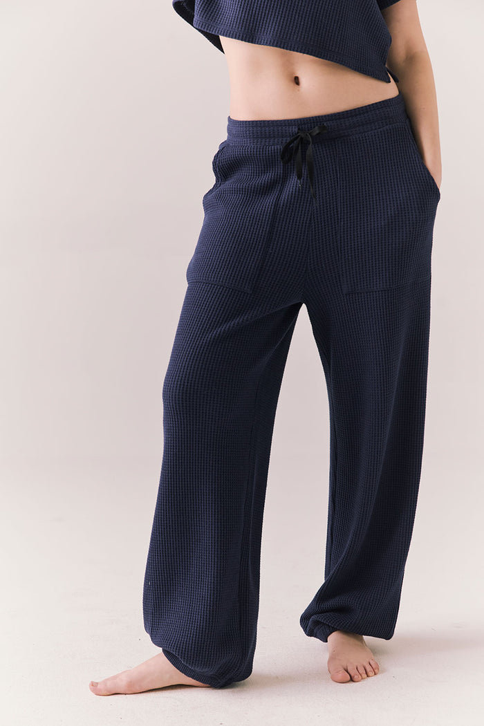 Front view of model wearing Billyy Joggers in midnight blue