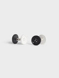 Pair of black and white button-style cufflinks on a grey background.