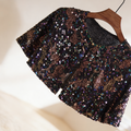 Black iridescent sequin bridal capelet with rainbow sparkle effect, short wedding shawl for evening gowns and formal dresses.