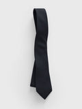 Black necktie looped and draped on a grey background.
