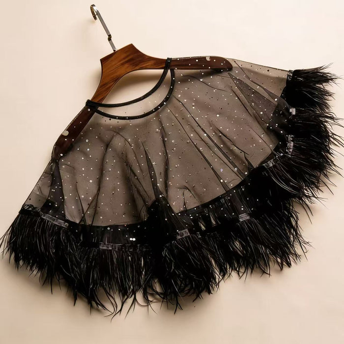 Handcrafted black feather bridal capelet featuring sheer tulle, sparkling embellishments and ostrich feather trim.
