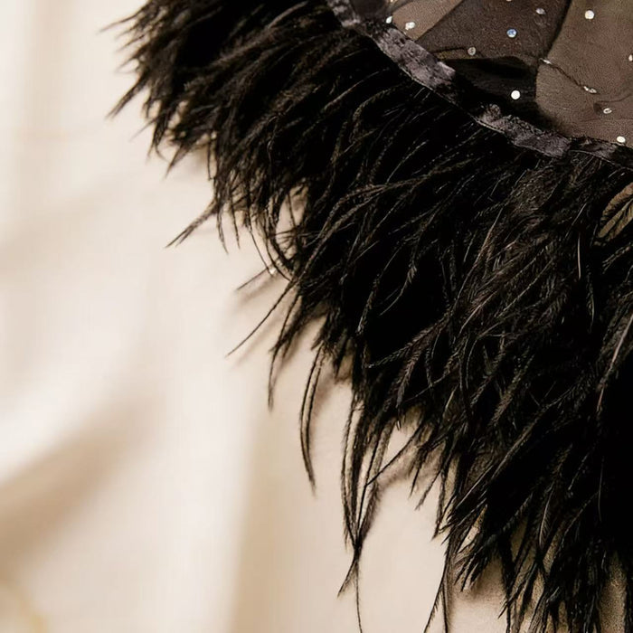 Handcrafted black feather bridal capelet featuring sheer tulle, sparkling embellishments and ostrich feather trim.
