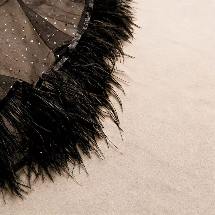 Handcrafted black feather bridal capelet featuring sheer tulle, sparkling embellishments and ostrich feather trim.