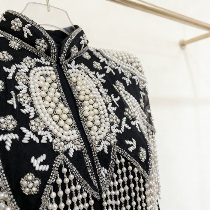 Luxury black and ivory bridal shoulder cape featuring faux pearl embroidery and elegant fringe.