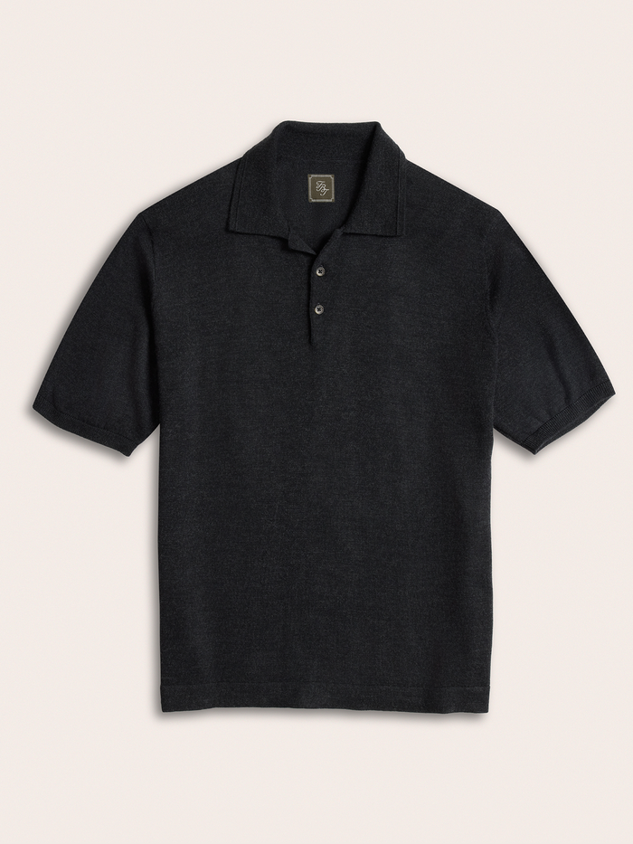 Black short-sleeve sweater polo, flat lay, front view, cream background.