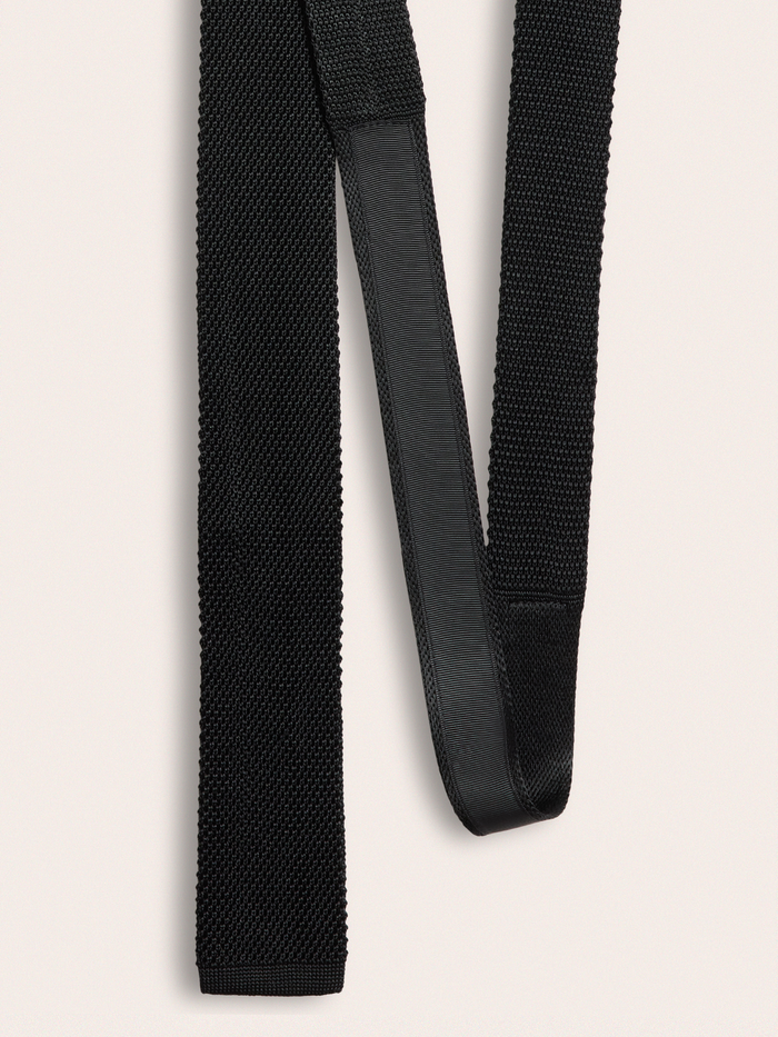 Back of black silk knit tie showing loop keeper and center seam.