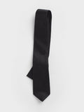 Black silk twill necktie loosely rolled with the blade pointing down on a white background