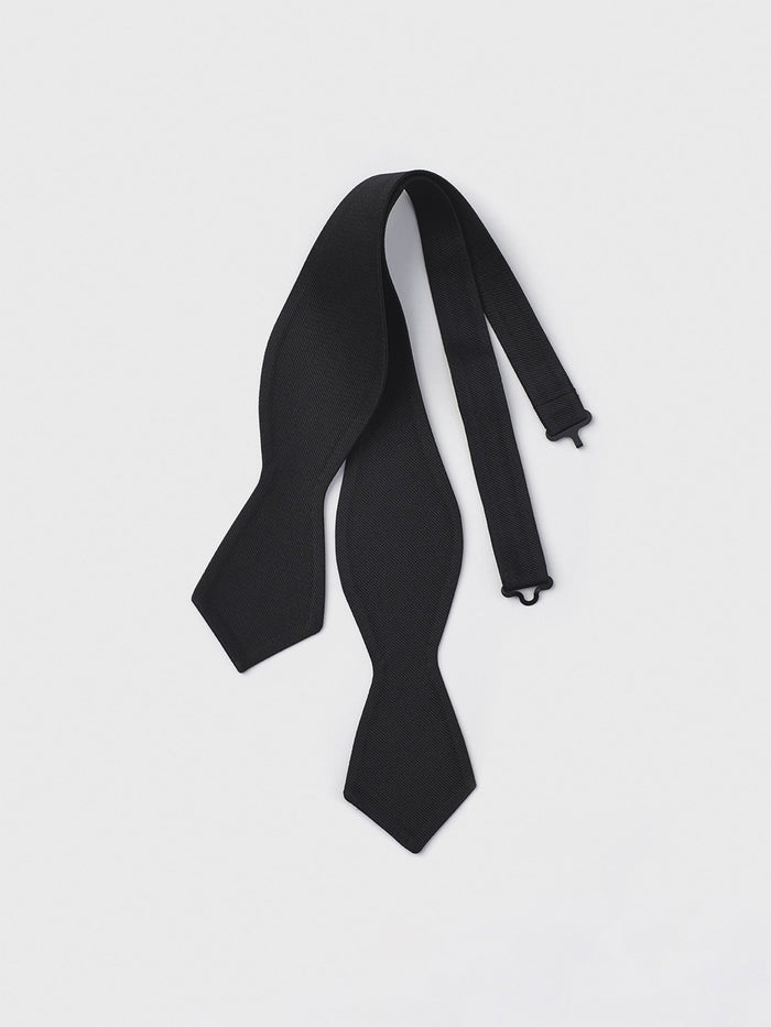 Untied black silk twill diamond-point bow tie laid flat on a white background.