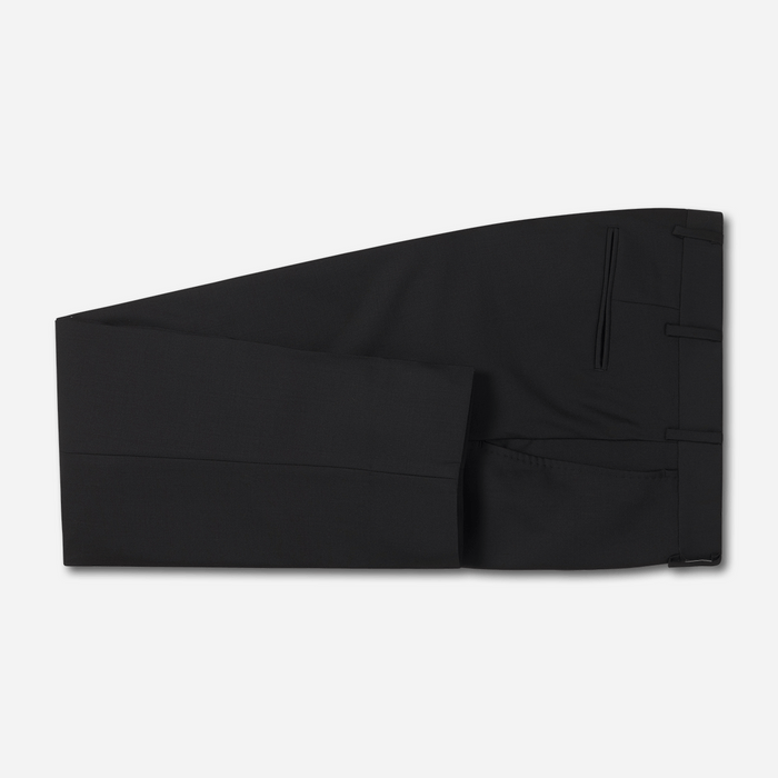 Black suit trousers, folded flat lay, grey background.
