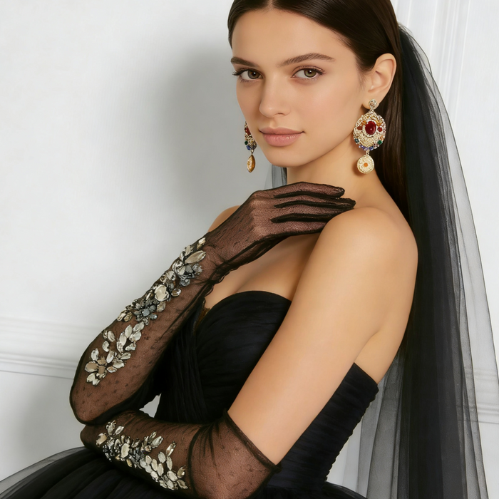 Bride wearing black crystal embellished tulle opera gloves with a formal gown for an elegant wedding or gala look.