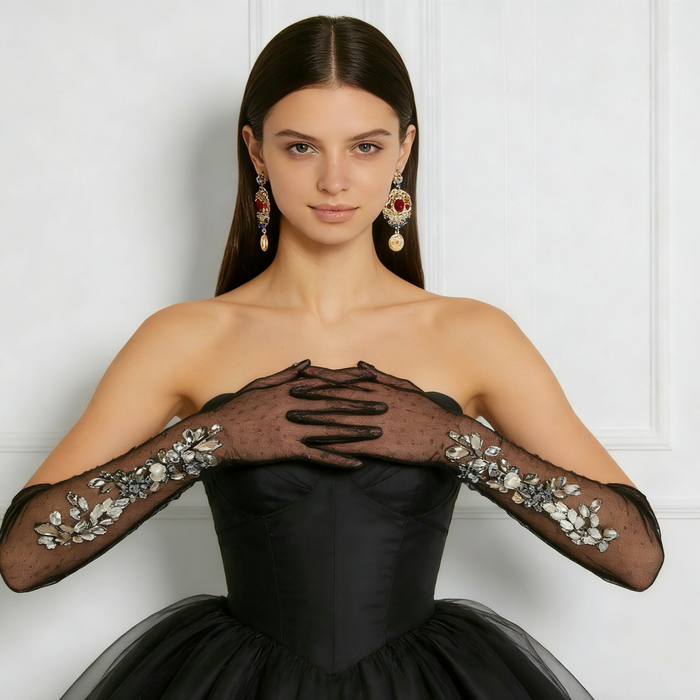 Bride wearing black crystal embellished tulle opera gloves with a formal gown for an elegant wedding or gala look.