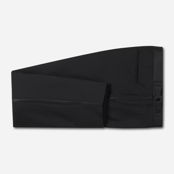 Black slim tuxedo trousers with satin side stripe, folded flat lay, grey background.
