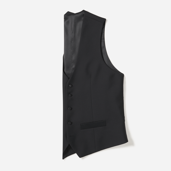 Black tuxedo vest, flat lay side view, satin back panel, white background.