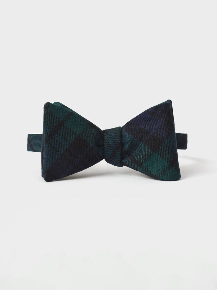 Black watch tartan bow tie, tied, on a white background.