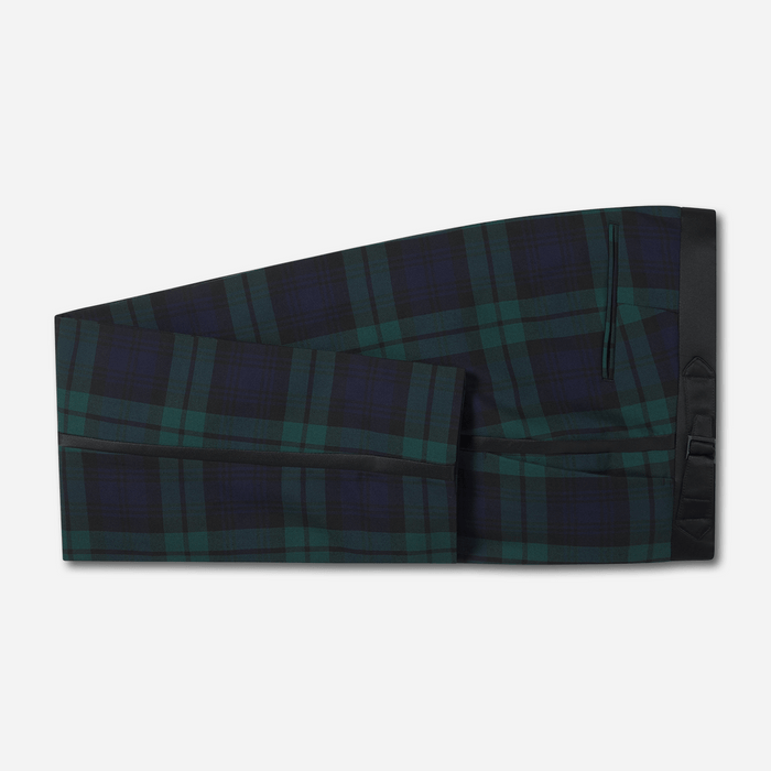 Black watch tartan tuxedo trousers with satin side stripe, folded flat lay, grey background.