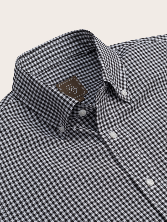 Close-up of a black and white gingham check shirt collar with brand tag.