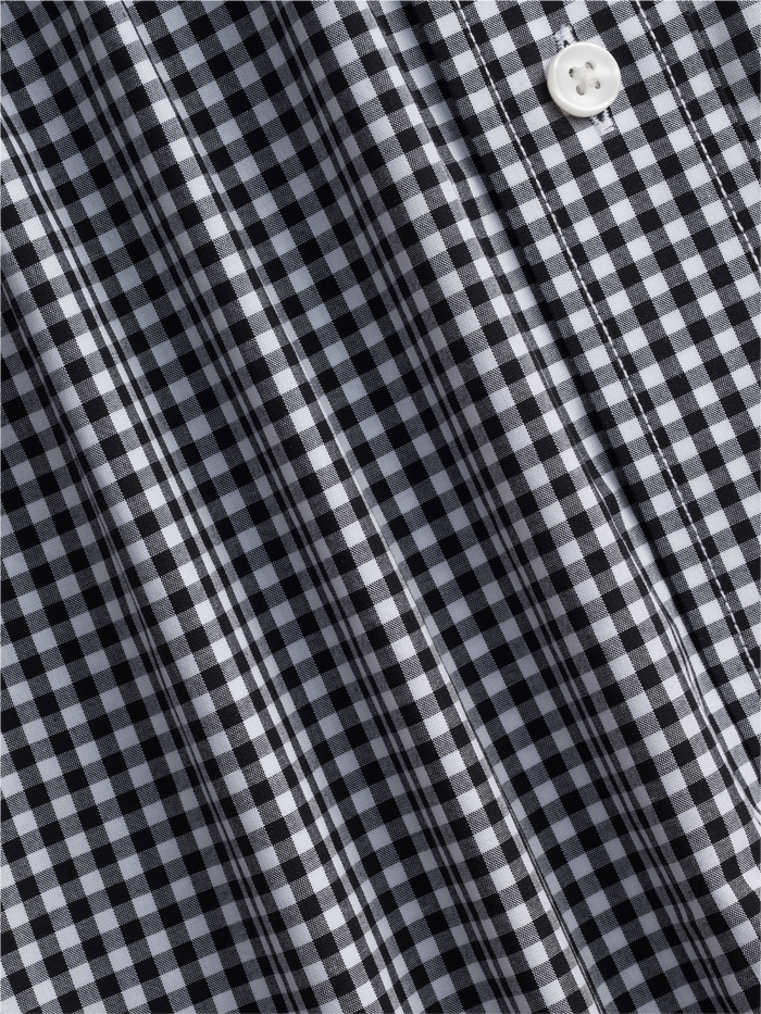 Close-up of black and white gingham check shirt fabric, draped to show pattern.