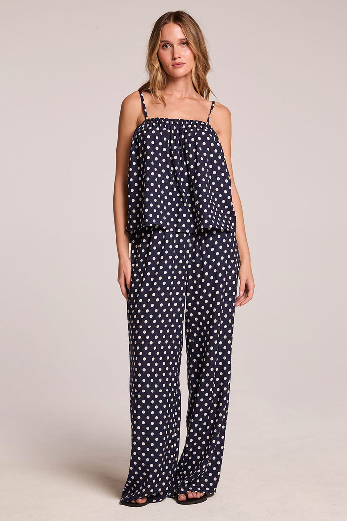 Full body front view of a woman wearing the Chaser  Blair Navy Spot Trouser and matching top on a neutral background