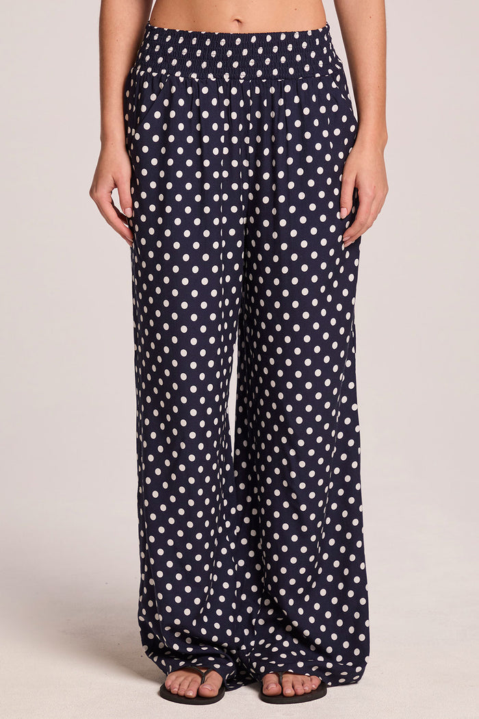 Front view of a woman wearing the Chaser  Blair Navy Spot Trouser on a neutral background