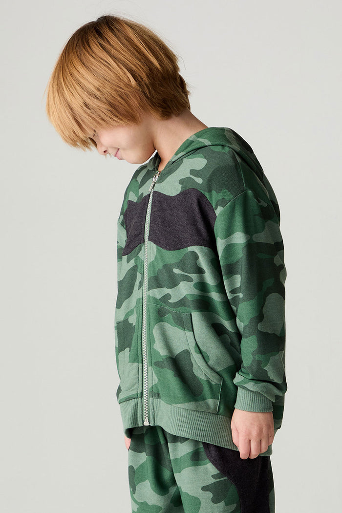 Side view of a boy wearing the Chaser Blocked Camo Boys Hoodie on a neutral background looking down