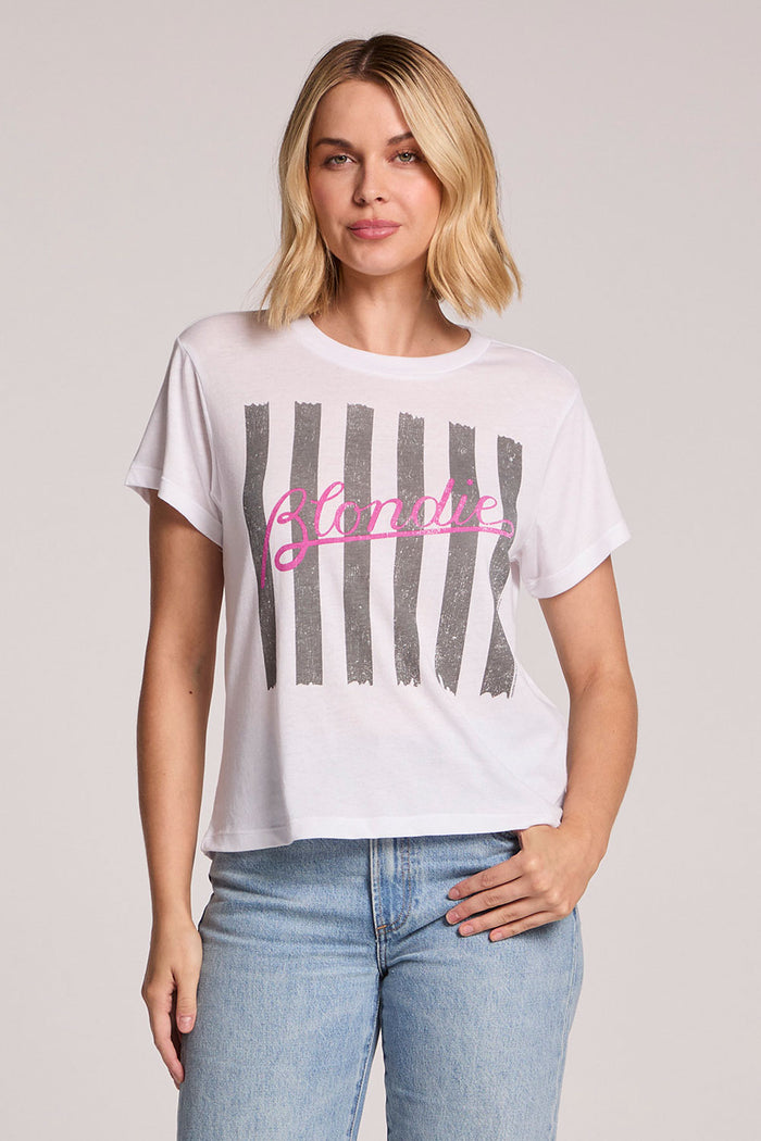 Front view of a woman wearing the Chaser  Blondie Parallel Lines Tee and jeans on a neutral background