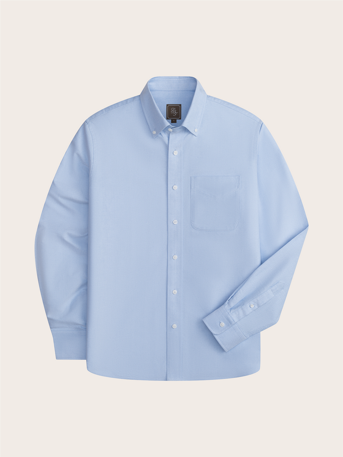 Light blue oxford shirt laid flat, front view with chest pocket and button-down collar.