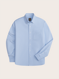 Light blue oxford shirt laid flat, front view with chest pocket and button-down collar.