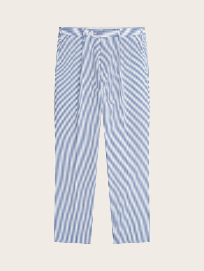 Blue and white striped seersucker trousers laid flat, pleated front, top-down view.