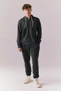 Full body view of model in Bolt Black Jogger Pants with matching hoodie.