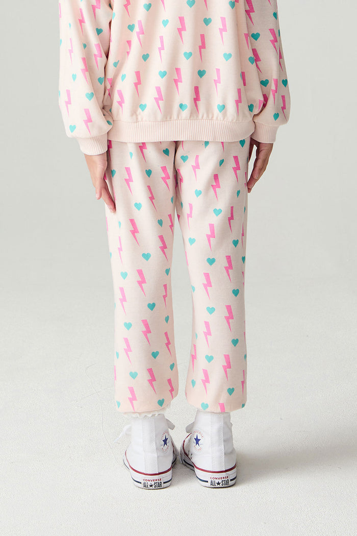 Back  view of a girl wearing the Chaser Bolt Hearts Girls Jogger on a neutral background with top