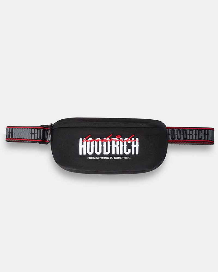 A black cross body bag with a wide, patterned black and red strap. The front features a bold white 'HOODRICH' logo with red graffiti-style lettering above it and smaller white text below reading 'FROM NOTHING TO SOMETHING'.