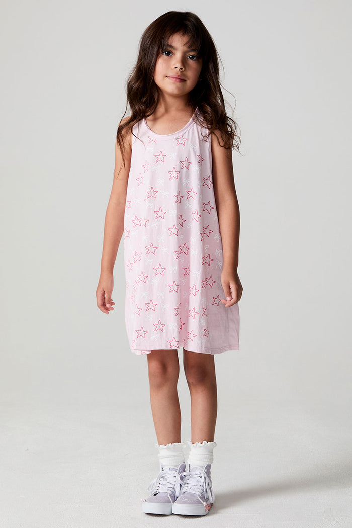 Front view of a girl wearing the Chaser Bows and Stars Dress and white shoes and socks on a neutral background