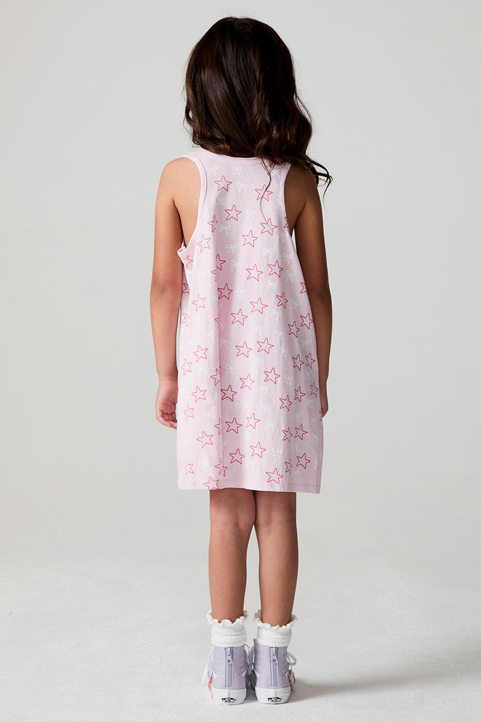 Back view of a girl wearing the Chaser Bows and Stars Dress on a neutral background
