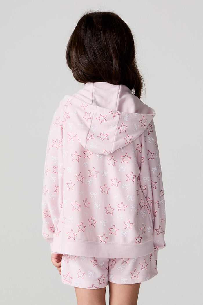 Back view of a girl wearing the Chaser Bows and Stars Zip-Up and matching shorts on a neutral background with arms at her sides