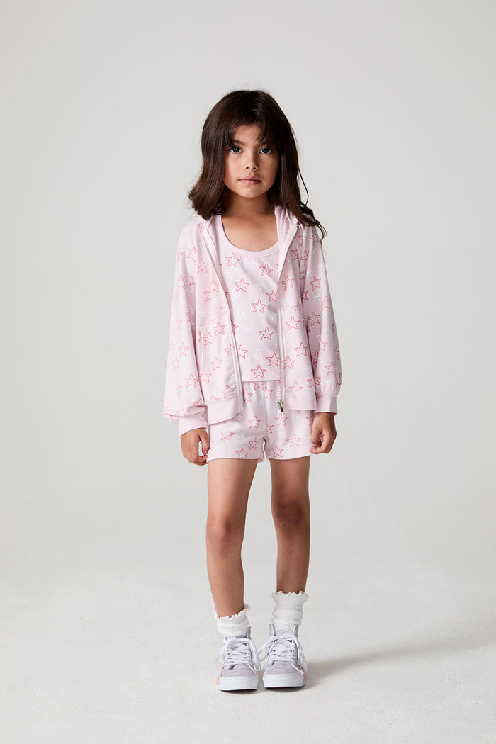 Front view of a girl wearing the Chaser Bows and Stars Zip-Up and matching shorts on a neutral background