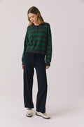 Full body view of woman wearing Chaser’s Boyfriend Timeless Stripe Pullover with matching Lilou Oxford Blue Joggers on a plain background.