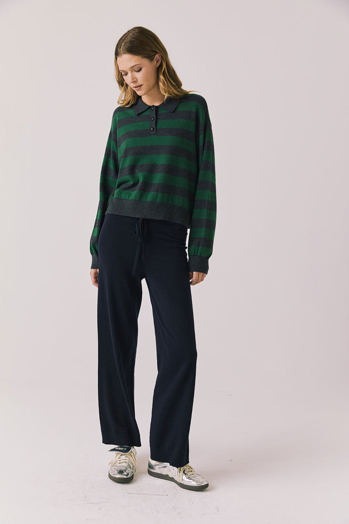 Full body view of woman wearing Chaser’s Boyfriend Timeless Stripe Pullover with matching Lilou Oxford Blue Joggers on a plain background.