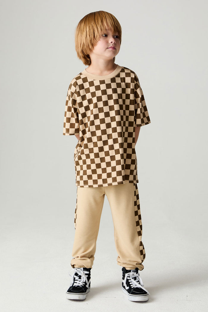 A full body front view of a boy wearing the Chaser Boys Solara Check Tee on a neutral background