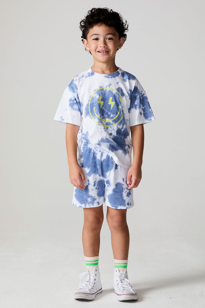 A full body front view of a boy wearing the Chaser Boys Mistel Tie Dye Smiley Face Tee on a neutral background