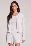 Front view of a woman wearing the Chaser  Brandy Light Heather Grey Button Up and shorts on a neutral background