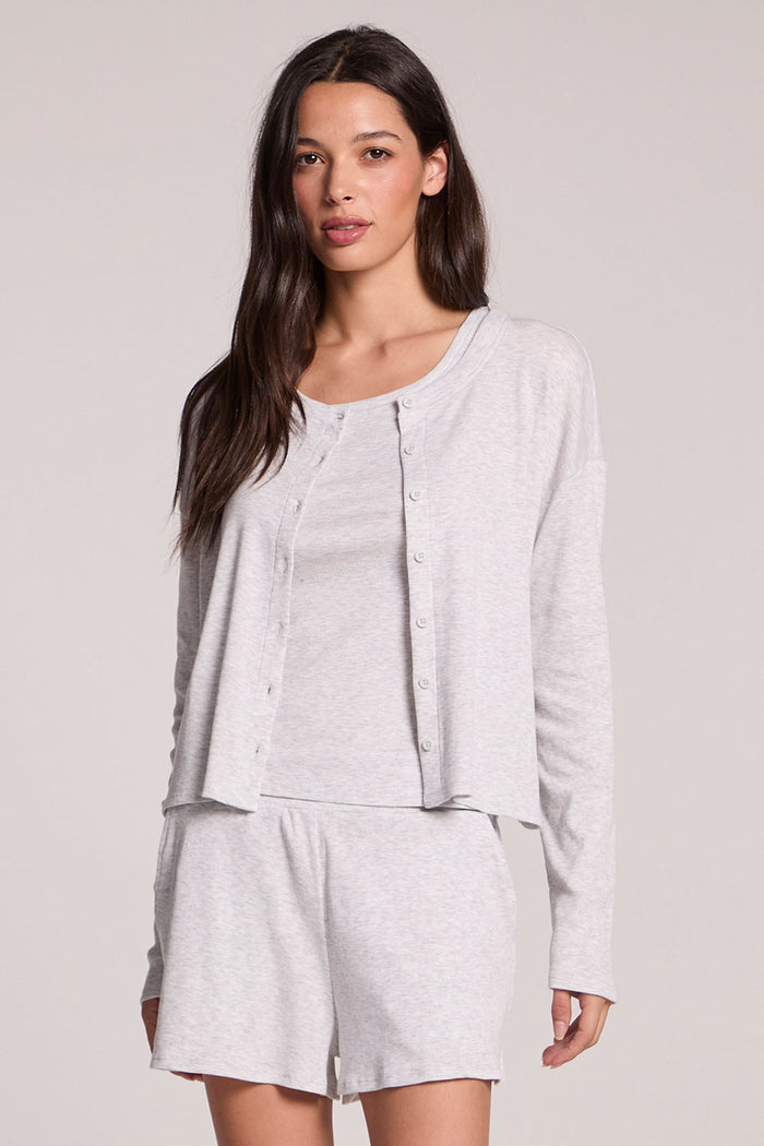 Front view of a woman wearing the Chaser  Brandy Light Heather Grey Button Up and shorts on a neutral background