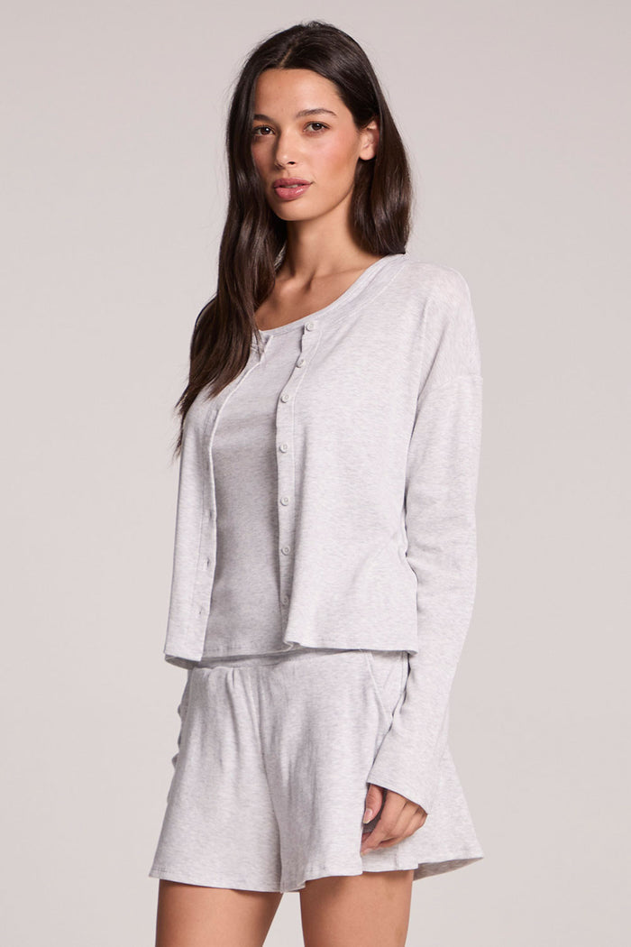 Side angle view of a woman wearing the Chaser  Brandy Light Heather Grey Button Up on a neutral background with arms at her sides
