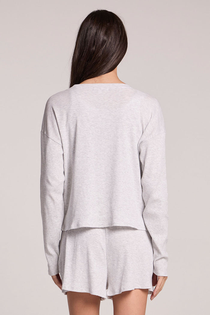 Back view of a woman wearing the Chaser  Brandy Light Heather Grey Button Up on a neutral background