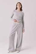 Full body view of woman wearing Chaser’s Brandy Light Heather Grey Joggers with matching Spritz Long Sleeve on a white background.