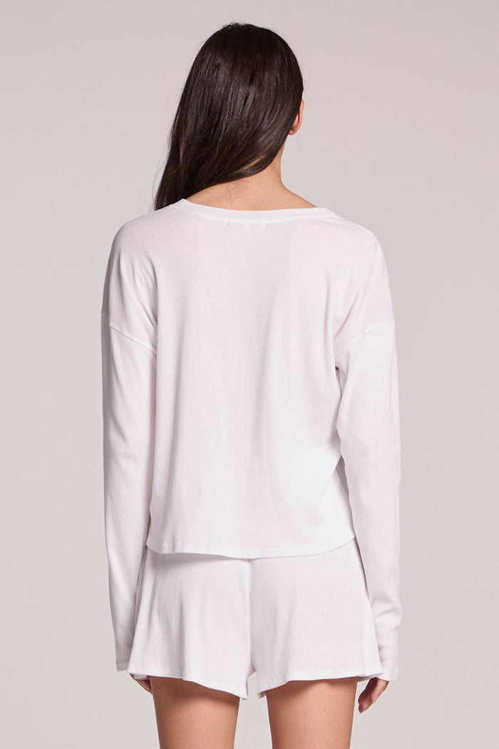 Back view of a woman wearing the Chaser  Brandy Button Up on a neutral background