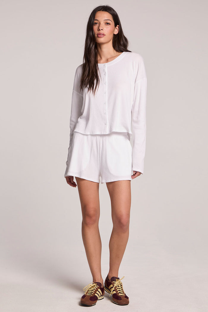 Front full body view of a woman wearing the Chaser  Brandy Button Up and sneakers on a neutral background