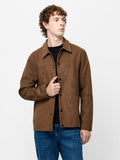 A man wearing a  Brown Faux Suede Jacket with a pointed collar, a button-through fastening and side pockets.