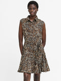 A woman wearing a leopard print, short sleeved, mini length swing dress with a shirt collar and button down fastening.
