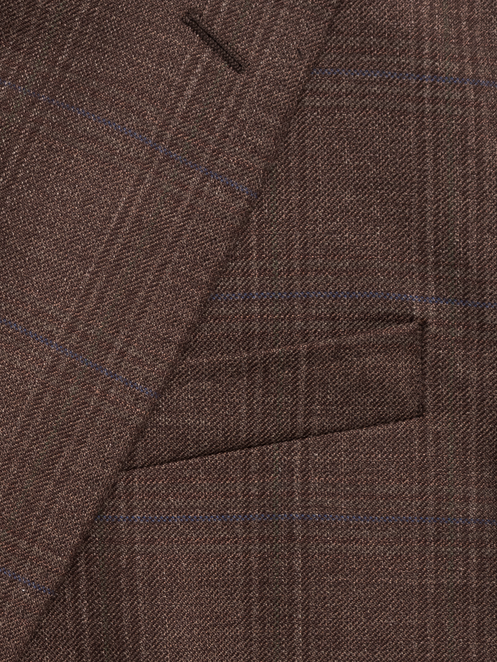 Close-up of a brown plaid sportcoat's lapel notch and chest pocket.
