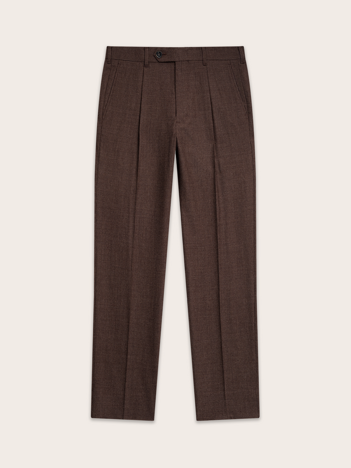Brown puppytooth trousers laid flat, pleated front, top-down view.